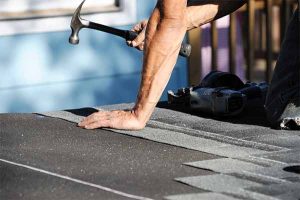 Manahawkin roofing contractor, Close-up of roofer hammering shingles
