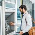 Customer smiling using outdoor ATM thanks to NCR ATM service